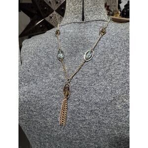 Gold tone with blue and amber colored accented.